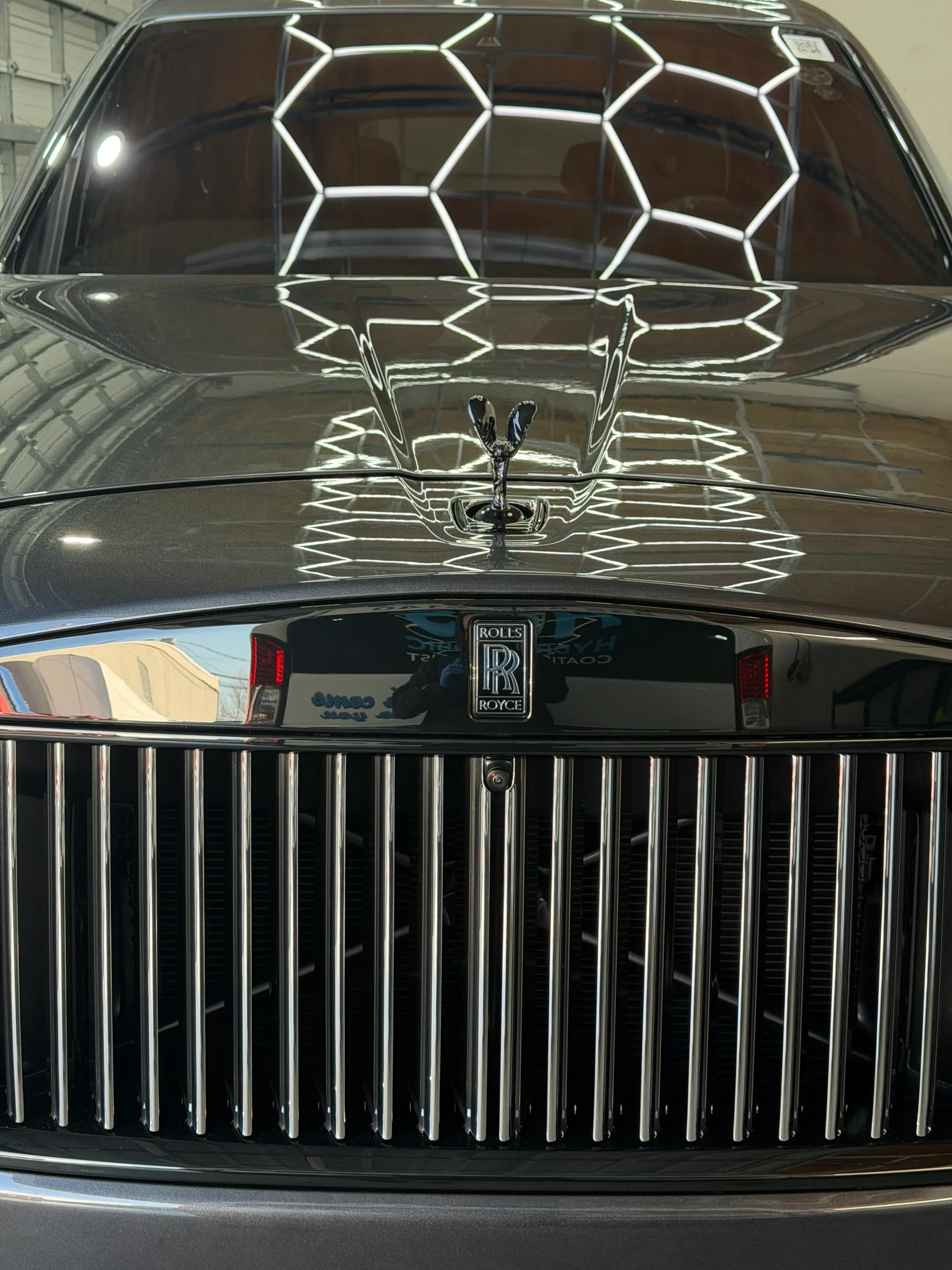 Close-up of a black Rolls-Royce finish showing gloss and reflection